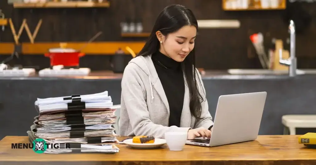 Woman in kitchen with paperwork